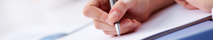 Close-up of hand writing with a pen