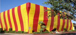 Large building wrapped in red and yellow stripes