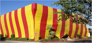 Large building covered with red and yellow stripes