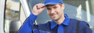 Smiling service technician tipping cap