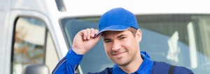 Smiling delivery driver in blue uniform
