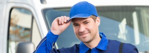 Delivery driver tipping cap in front of van