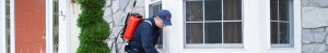 Technician with red sprayer treating house exterior