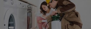 Exterminator inspecting kitchen with homeowner