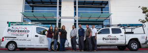 Pest control crew standing by branded vans