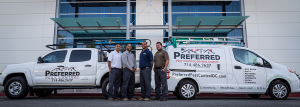 Four pest control technicians with two company vans