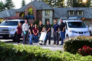 Home service team with vans outside house