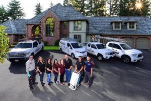 Residential service team with vans in driveway