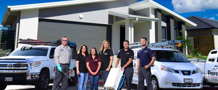 Home service team with vans outside modern house