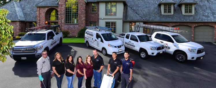 Residential service team with vans in driveway