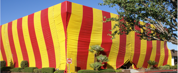 Large building covered with red and yellow stripes