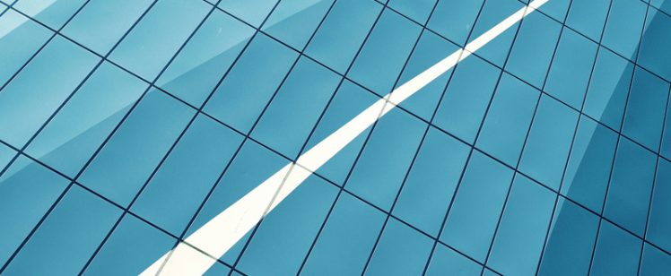 Blue glass facade with diagonal white reflection