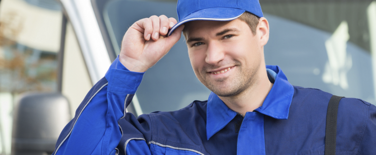 Smiling service technician tipping cap