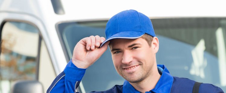 Smiling delivery driver in blue uniform